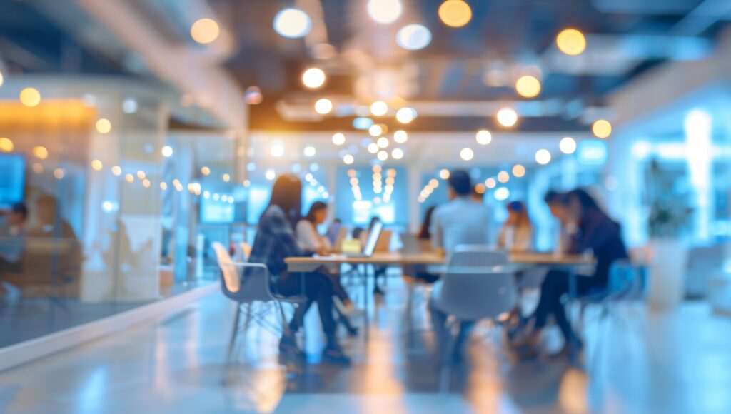 Blurred background of a modern office interior with blurred business people working in a team at a table